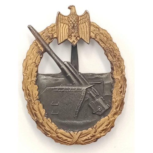 33 - A WW2 Kriegsmarine Coastal Artillery Badge. Marked 65 on the reverse.