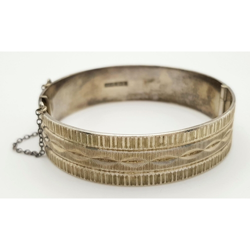 423 - A Vintage Solid Silver 925 Bangle, 40.5 grams, Approx. 6cm diameter, with safety chain. In very good... 