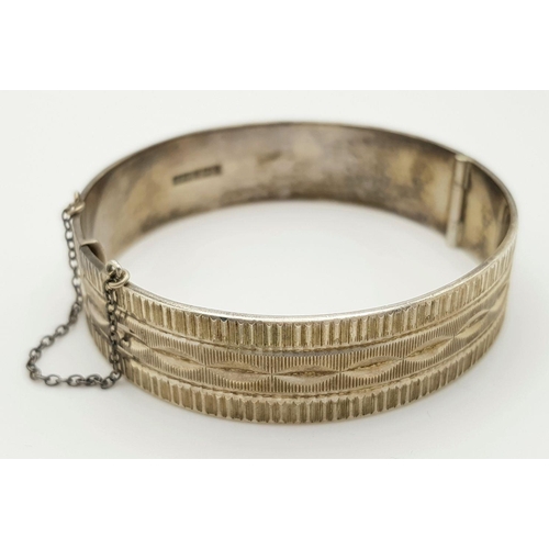 423 - A Vintage Solid Silver 925 Bangle, 40.5 grams, Approx. 6cm diameter, with safety chain. In very good... 