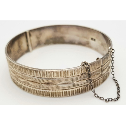 423 - A Vintage Solid Silver 925 Bangle, 40.5 grams, Approx. 6cm diameter, with safety chain. In very good... 