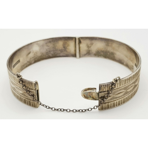 423 - A Vintage Solid Silver 925 Bangle, 40.5 grams, Approx. 6cm diameter, with safety chain. In very good... 