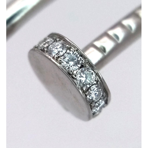 1659 - An 18K White Gold Diamond Nail Design Bangle. 8.4g total weight. NL94204