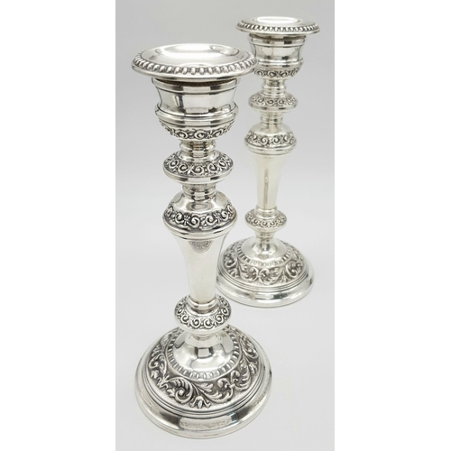 2296 - A Pair of Ornate Sterling Silver Candlesticks. Birmingham hallmarks. 24cm tall. 988g total weight.