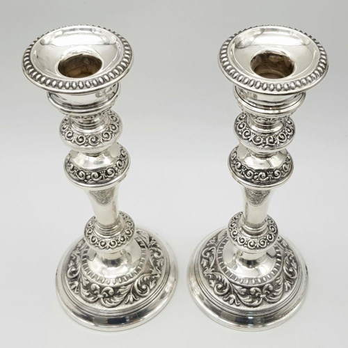 2296 - A Pair of Ornate Sterling Silver Candlesticks. Birmingham hallmarks. 24cm tall. 988g total weight.