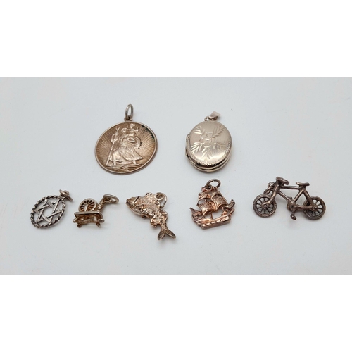 1715 - An assorted collection of 7 sterling silver pendants/charms. Total weight 15G. Please see photos for... 