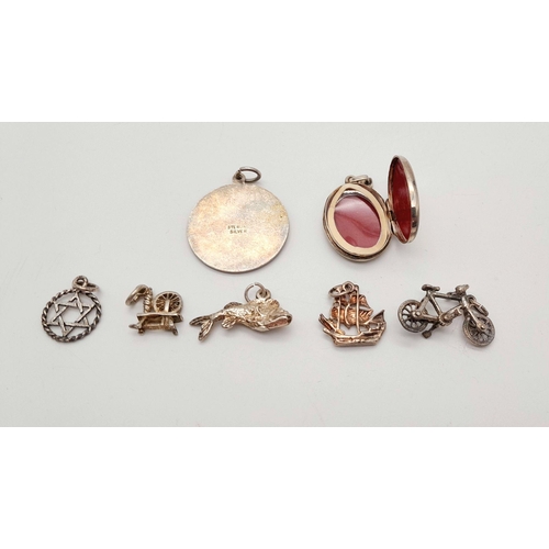 1715 - An assorted collection of 7 sterling silver pendants/charms. Total weight 15G. Please see photos for... 