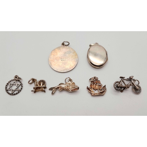 1715 - An assorted collection of 7 sterling silver pendants/charms. Total weight 15G. Please see photos for... 