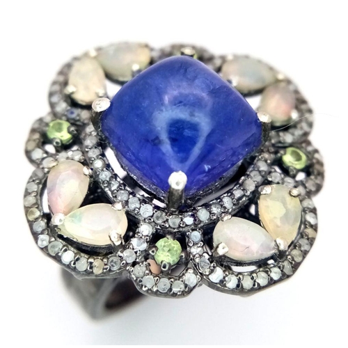 1945 - A 5.10ct Cabochon Tanzanite Ring with 2.3ct diamond accents and 3ct moonstone, set in 925 silver. To... 