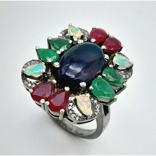 1952 - A 925 silver ring featuring a central black opal, accented with emeralds, rubies, and moonstones, co... 