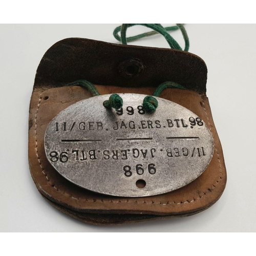 893 - A WW2 German Mountain Troop Soldiers Dog Tag in a leather Pouch to prevent the cold metal from touch... 