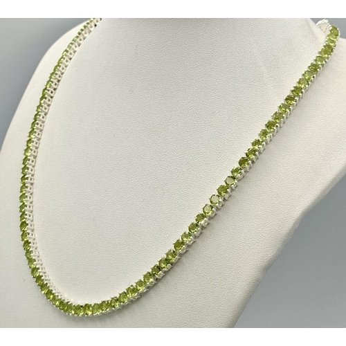 107 - A Peridot Gemstone Tennis Necklace. Set in 925 Silver. 44cm length. CD-1599