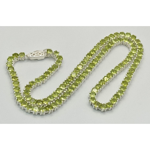 107 - A Peridot Gemstone Tennis Necklace. Set in 925 Silver. 44cm length. CD-1599