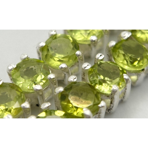 107 - A Peridot Gemstone Tennis Necklace. Set in 925 Silver. 44cm length. CD-1599