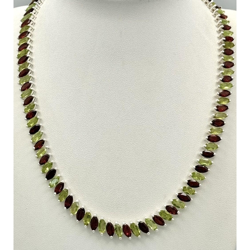 128 - A Marquise Cut Peridot and Garnet Gemstone Tennis Necklace. Set in 925 Silver. 44cm. CD-1612