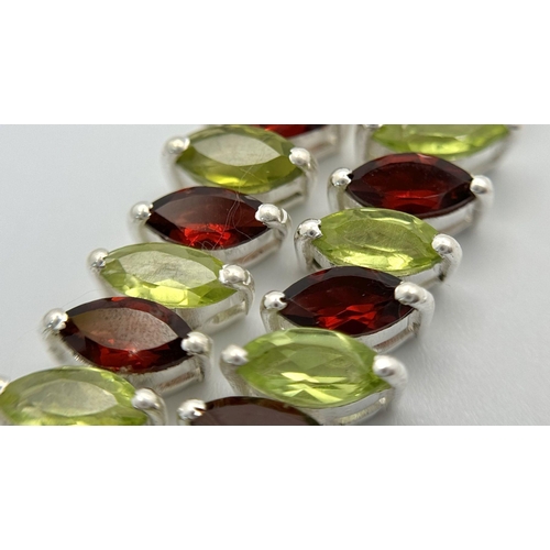 128 - A Marquise Cut Peridot and Garnet Gemstone Tennis Necklace. Set in 925 Silver. 44cm. CD-1612