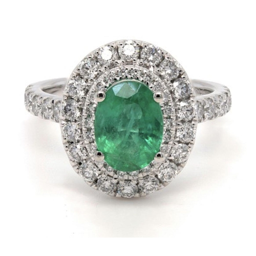 211 - A Platinum Cluster Ring, featuring a 1.27ct Oval Emerald surrounded by a halo of Round Brilliant-Cut... 