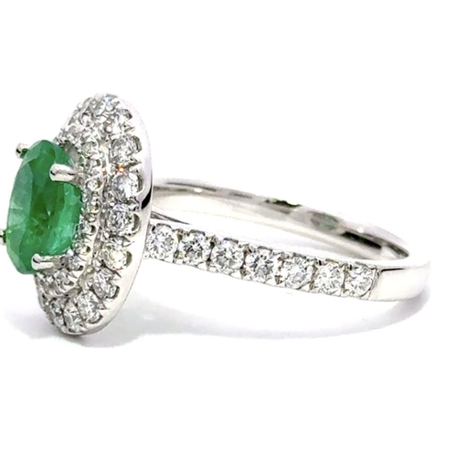 211 - A Platinum Cluster Ring, featuring a 1.27ct Oval Emerald surrounded by a halo of Round Brilliant-Cut... 