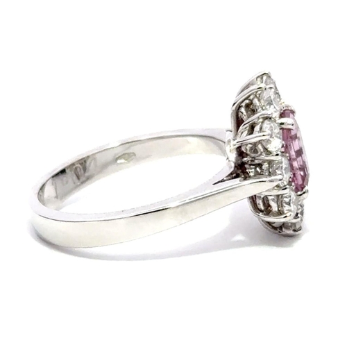 225 - An 18K Platinum Cluster Ring, featuring a 1.29ct Emerald-Cut Pink Sapphire surrounded by a halo of R... 