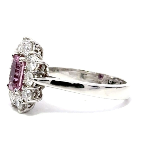 225 - An 18K Platinum Cluster Ring, featuring a 1.29ct Emerald-Cut Pink Sapphire surrounded by a halo of R... 