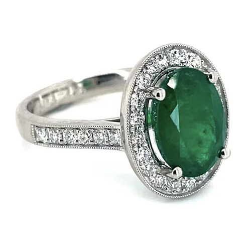 407 - A Platinum Cluster Ring, featuring a 2.07ct Oval Emerald surrounded by a halo of Round Brilliant-Cut... 