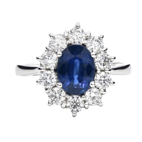 603 - A Platinum Cluster Ring, featuring a 1.43ct Oval Blue Sapphire surrounded by a halo of Round Brillia... 