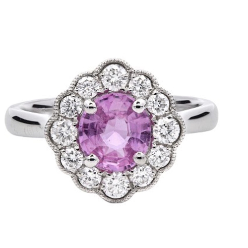 715 - A Platinum Cluster Ring, featuring a 1.07ct Oval Pink Sapphire surrounded by a halo of Round Brillia... 