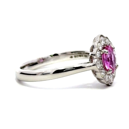 715 - A Platinum Cluster Ring, featuring a 1.07ct Oval Pink Sapphire surrounded by a halo of Round Brillia... 