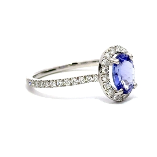 729 - A Platinum Cluster Ring, featuring a 1.15ct Oval Tanzanite surrounded by a halo of Round Brilliant-C... 