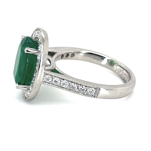 617 - An 18K Platinum Cluster Ring, featuring a 3.43ct Oval Emerald surrounded by a halo of Round Brillian... 