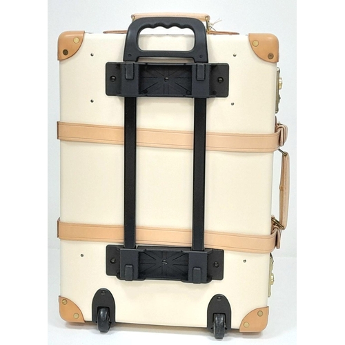 100 - A Globe-Trotter Beigh Plastic Suitcase. Plastic exterior with leather accents and gold-toned hardwar... 