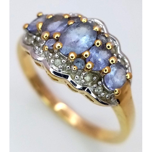 829 - A Yellow Gold Gilt Sterling Silver ‘50th Anniversary Edition’ Tanzanite and White Topaz Set Ring Siz... 