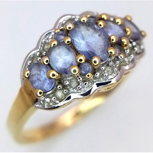 829 - A Yellow Gold Gilt Sterling Silver ‘50th Anniversary Edition’ Tanzanite and White Topaz Set Ring Siz... 