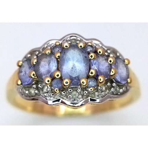 829 - A Yellow Gold Gilt Sterling Silver ‘50th Anniversary Edition’ Tanzanite and White Topaz Set Ring Siz... 