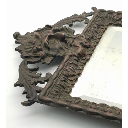 212 - A superb Antique Bronze Mirror of Quality - with a Bacchus type head at each end and original bevell... 