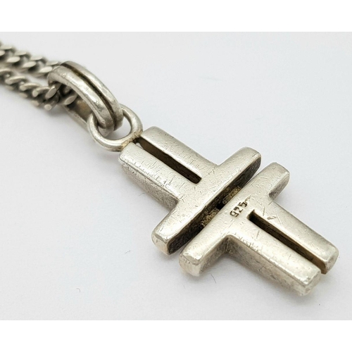 550 - A 925 Silver Cross Pendant on Chain. 3.8cm pendant, 56cm chain. 18.14g total weight.