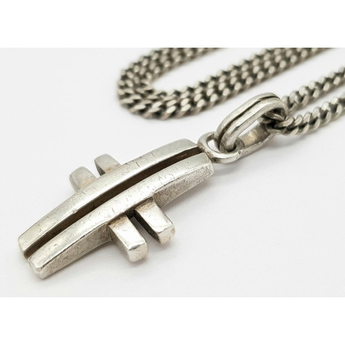 550 - A 925 Silver Cross Pendant on Chain. 3.8cm pendant, 56cm chain. 18.14g total weight.