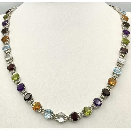 619 - A Sterling Silver Multi-Gemstone Set Necklace. 46cm Length. Set with Forty 8mm Oval Cut Semi-Preciou... 