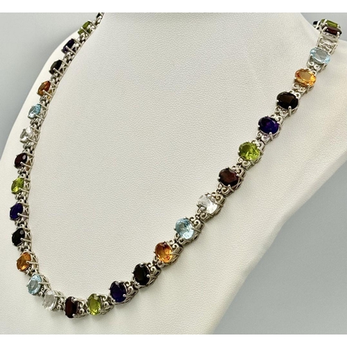 619 - A Sterling Silver Multi-Gemstone Set Necklace. 46cm Length. Set with Forty 8mm Oval Cut Semi-Preciou... 