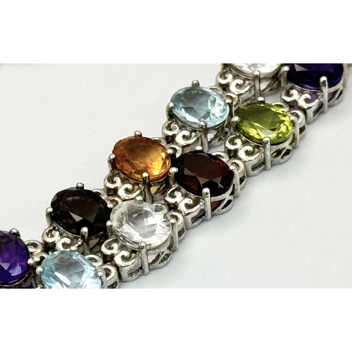 619 - A Sterling Silver Multi-Gemstone Set Necklace. 46cm Length. Set with Forty 8mm Oval Cut Semi-Preciou... 