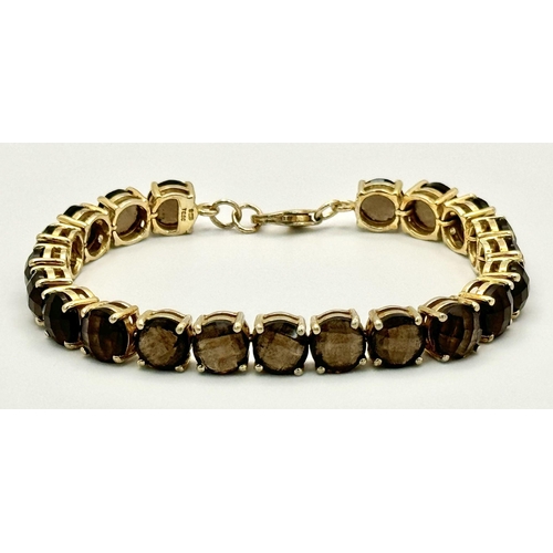 794 - A Vintage Yellow Gold Gilt Sterling Silver and Smoky Quartz Tennis Bracelet. 19.5cm Length. Set with... 