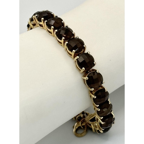 794 - A Vintage Yellow Gold Gilt Sterling Silver and Smoky Quartz Tennis Bracelet. 19.5cm Length. Set with... 