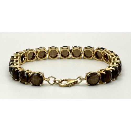 794 - A Vintage Yellow Gold Gilt Sterling Silver and Smoky Quartz Tennis Bracelet. 19.5cm Length. Set with... 