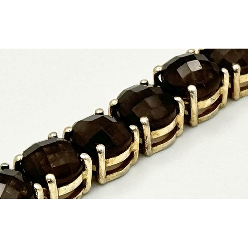 794 - A Vintage Yellow Gold Gilt Sterling Silver and Smoky Quartz Tennis Bracelet. 19.5cm Length. Set with... 