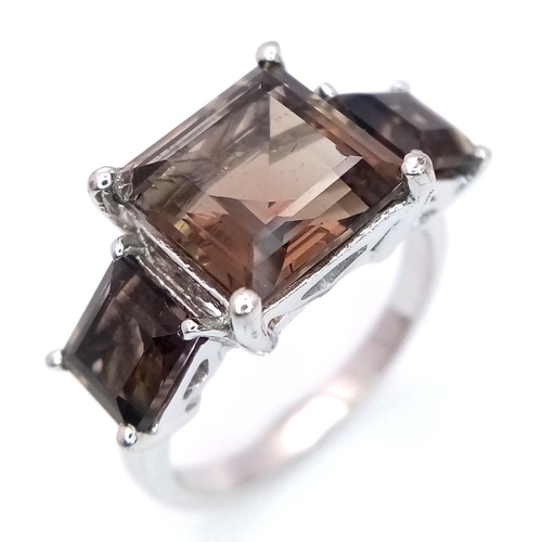 990 - A Sterling Silver Smoky Quartz Trilogy Ring Size R. The Centre Stone Measures 1cm Square and the Thr... 