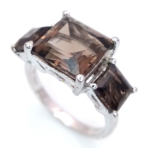 990 - A Sterling Silver Smoky Quartz Trilogy Ring Size R. The Centre Stone Measures 1cm Square and the Thr... 