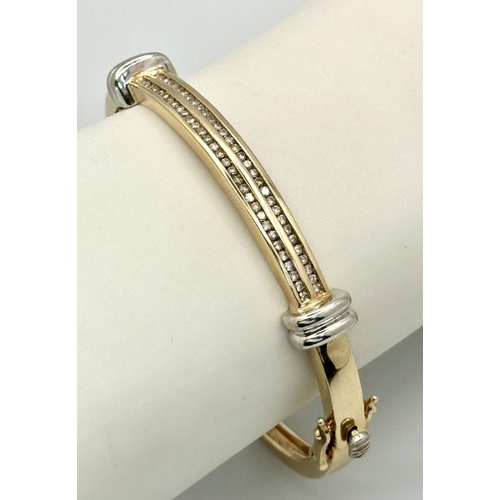 121 - A Stylish 9K Yellow and White Gold, Diamond Bangle. 62 small round cut diamonds over two levels. Cli... 