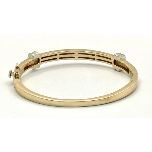 121 - A Stylish 9K Yellow and White Gold, Diamond Bangle. 62 small round cut diamonds over two levels. Cli... 