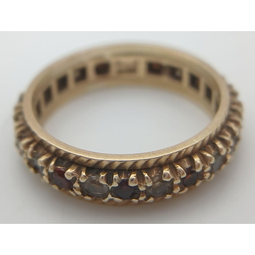 182 - Classic 9 carat GOLD,GEMSTONE SET ETERNITY RING. Full UK hallmark. Complete with ring box. 3 grams. ... 