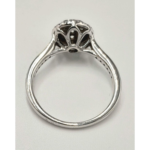 528 - A 9K White Gold Diamond Cluster Ring. Two circular levels and shoulders of diamonds. Size L 1/2. 3.4... 