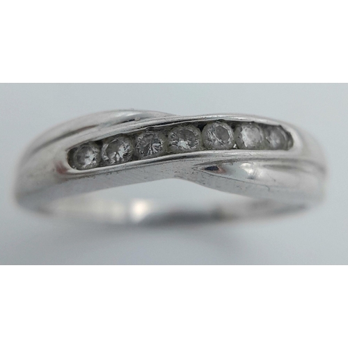 561 - A 9k white gold diamond cross-over ring, 0.14ct diamond weight, 2.1g total weight, size M. Ref: PWN3... 